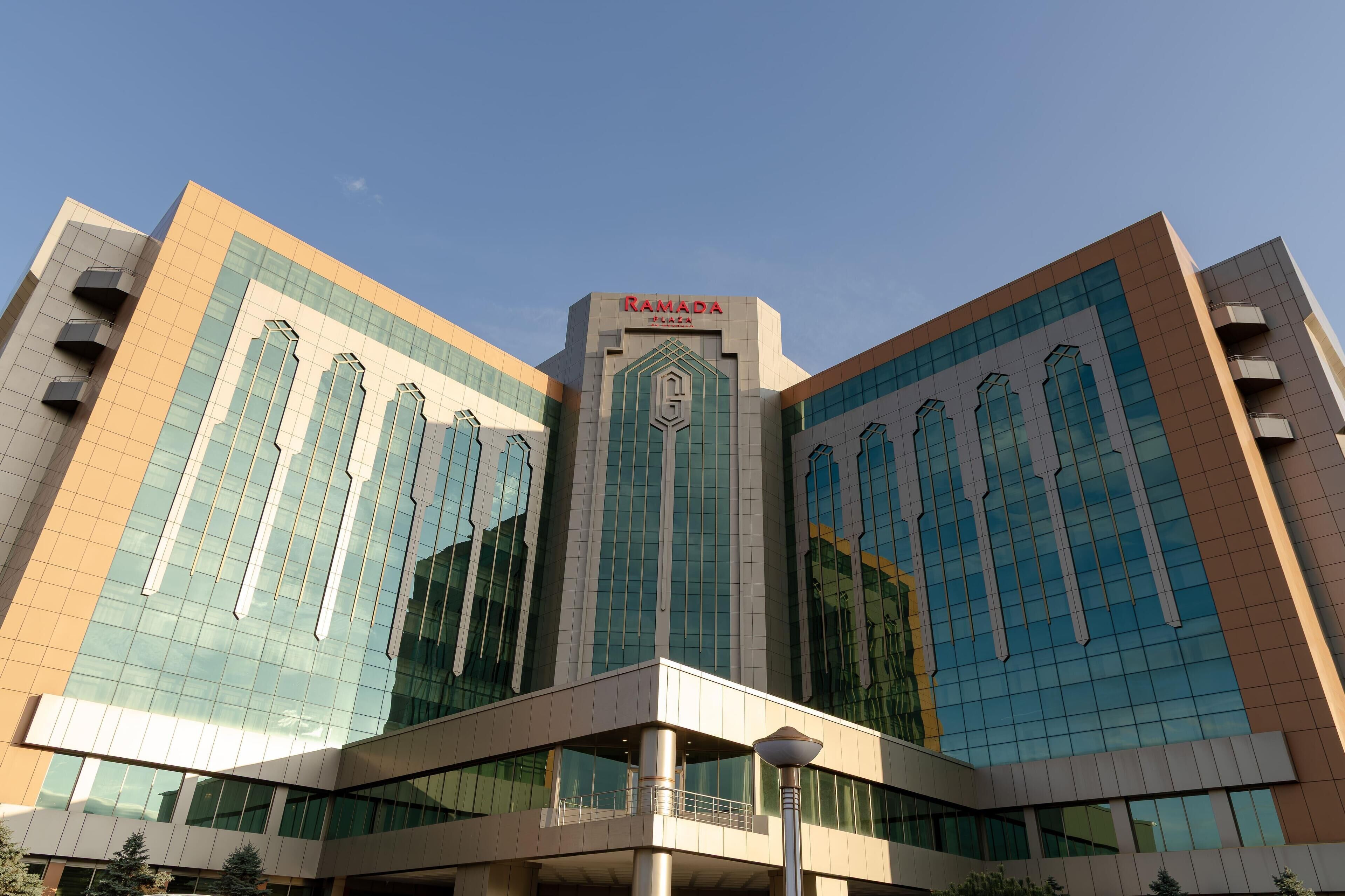 A modern building with a prominent sign reading "RAMADA".