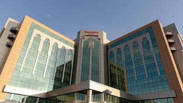 A modern building with a prominent sign reading "RAMADA".
