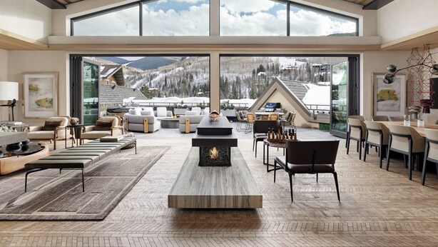A spacious living area with a fireplace, comfortable seating, and large windows offering a mountain view. - Four Seasons Resort and Residences Vail (Vail)