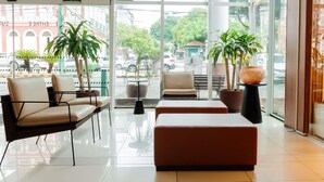 A modern lobby with seating, large windows, and potted plants. - ibis Styles Manaus (Manaus)