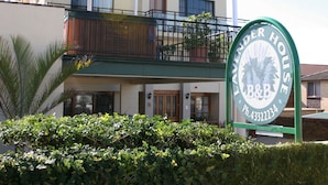 A two-story building with a balcony and a sign that reads "Lavender House." - Lavender House B&B (The Entrance)