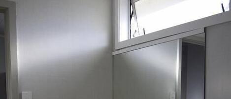 A bathroom with a white sink, a mirror, and a towel rack.