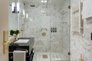 A modern bathroom with a glass-enclosed shower, a black sink, and a marble wall. - Altis Avenida Hotel, member of Preferred Hotels & Resorts (Lisbon)