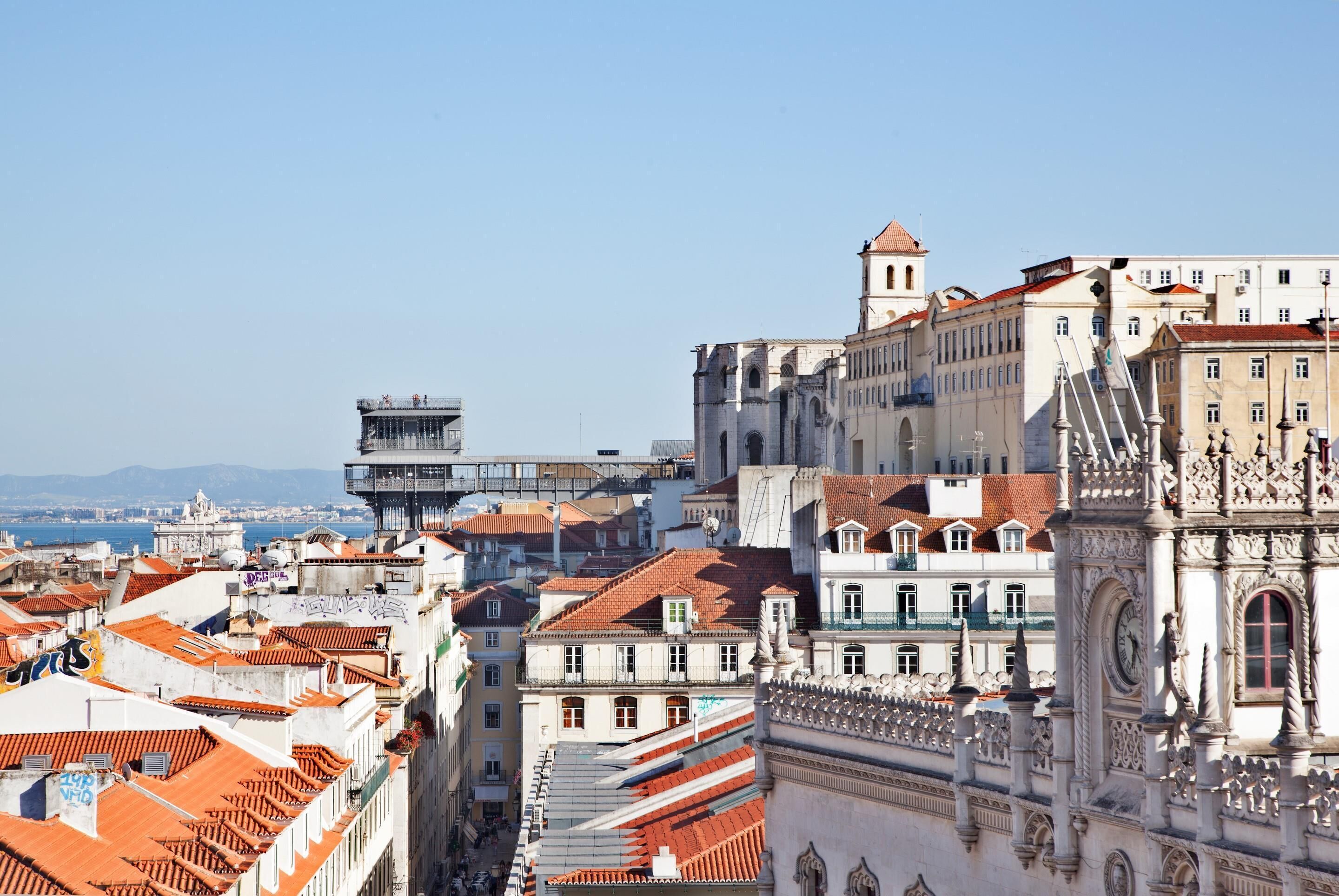 A cityscape with historic buildings, including a prominent tower and ornate architecture.