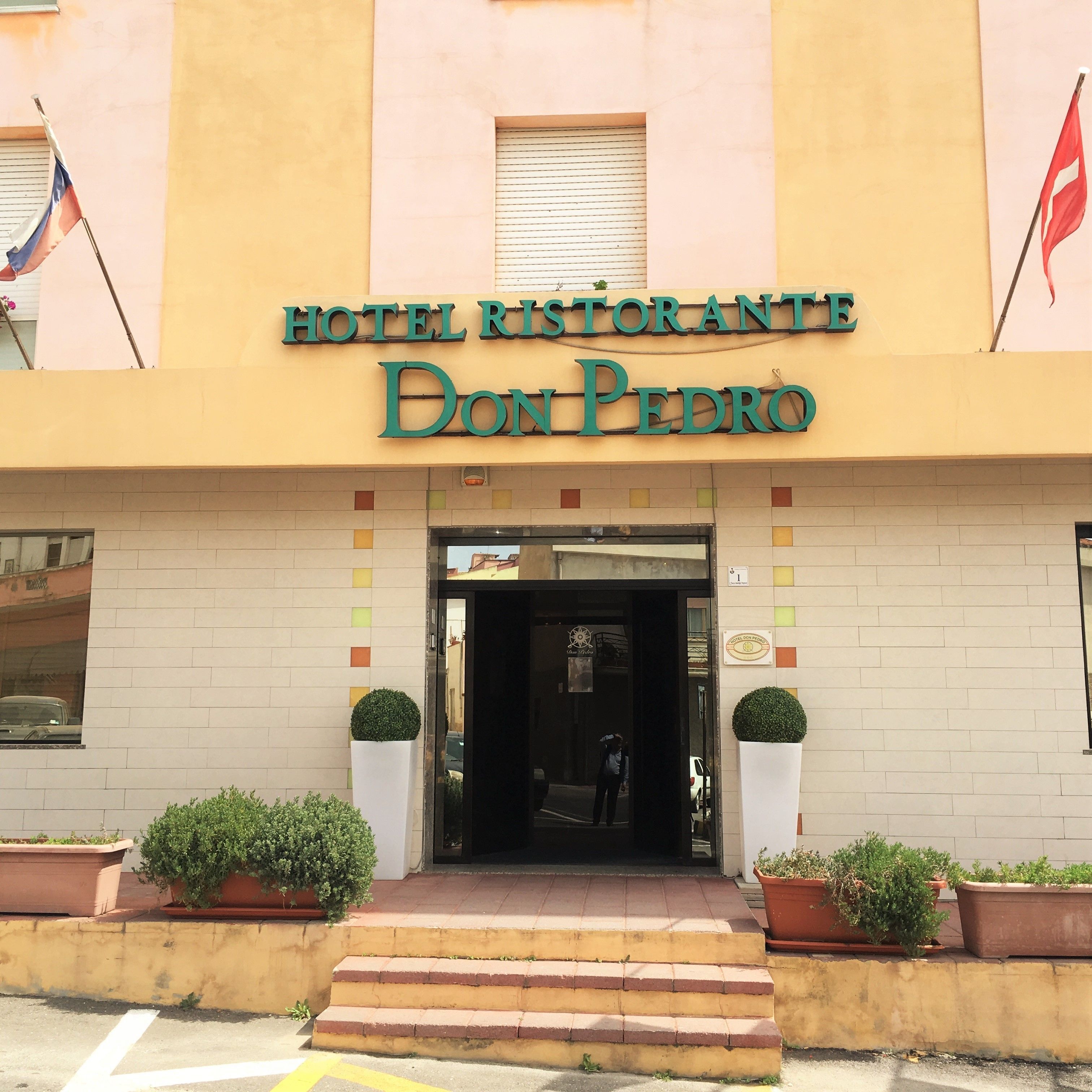 A hotel entrance with a sign reading "HOTEL RESTORANTE Don Pedro".