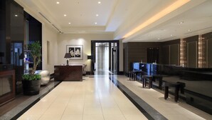 A spacious lobby with a reception desk, seating area, and a large mirror. - Hotel Trusty Tokyo Bayside (Tokyo)