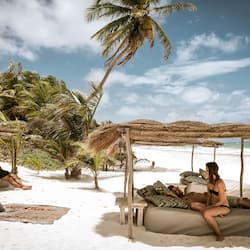 On the beach, white sand, sun loungers, beach towels