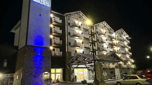 A multi-story hotel with a prominent sign reading "THE WILDEN" at the entrance. - The Walden, Trademark Collection By Wyndham (Pigeon Forge)