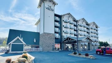 A multi-story hotel with a prominent sign reading "THE WALDEN." It features a stone facade, multiple balconies, and a covered entrance area.