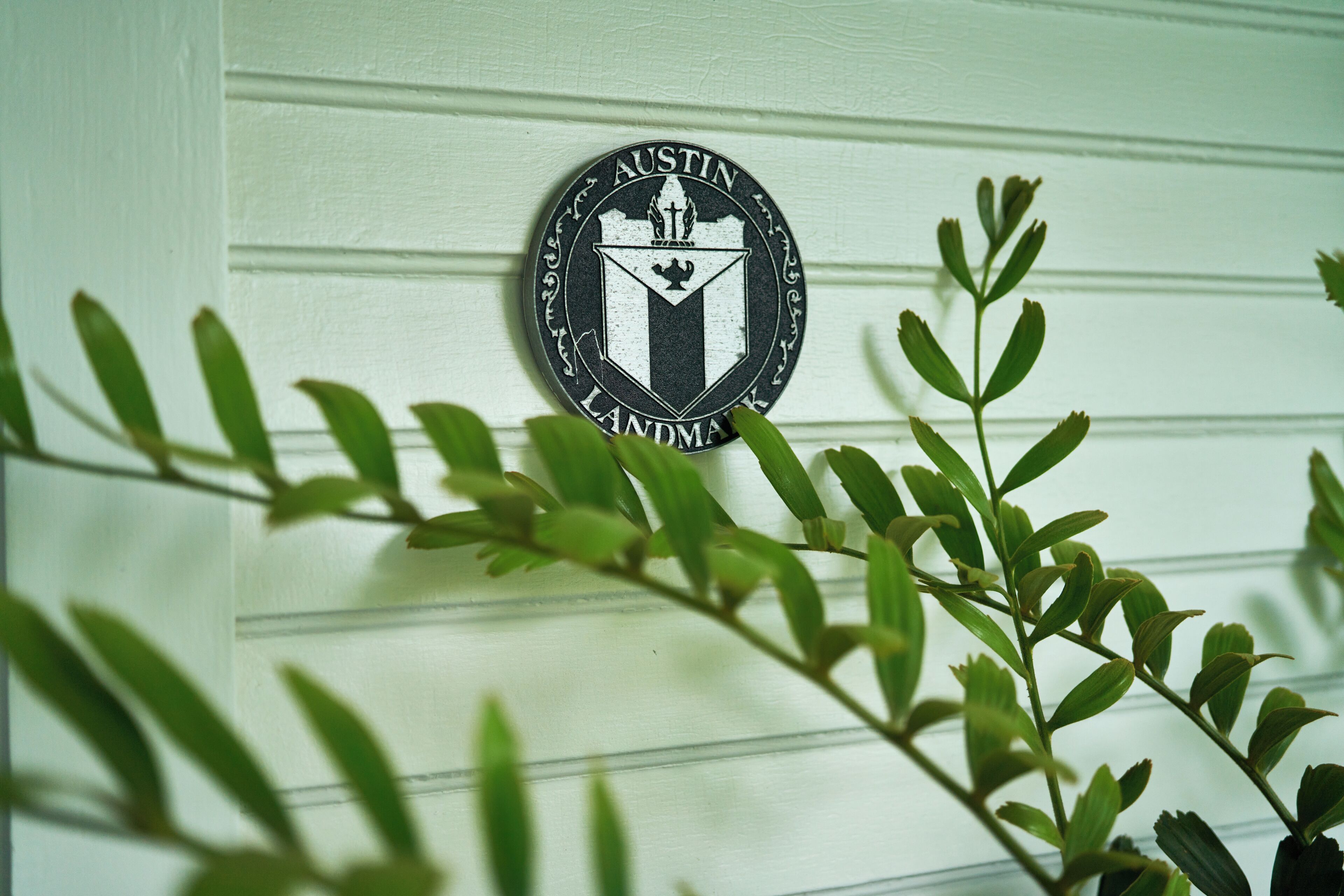 A wall with a circular emblem featuring text and a shield.