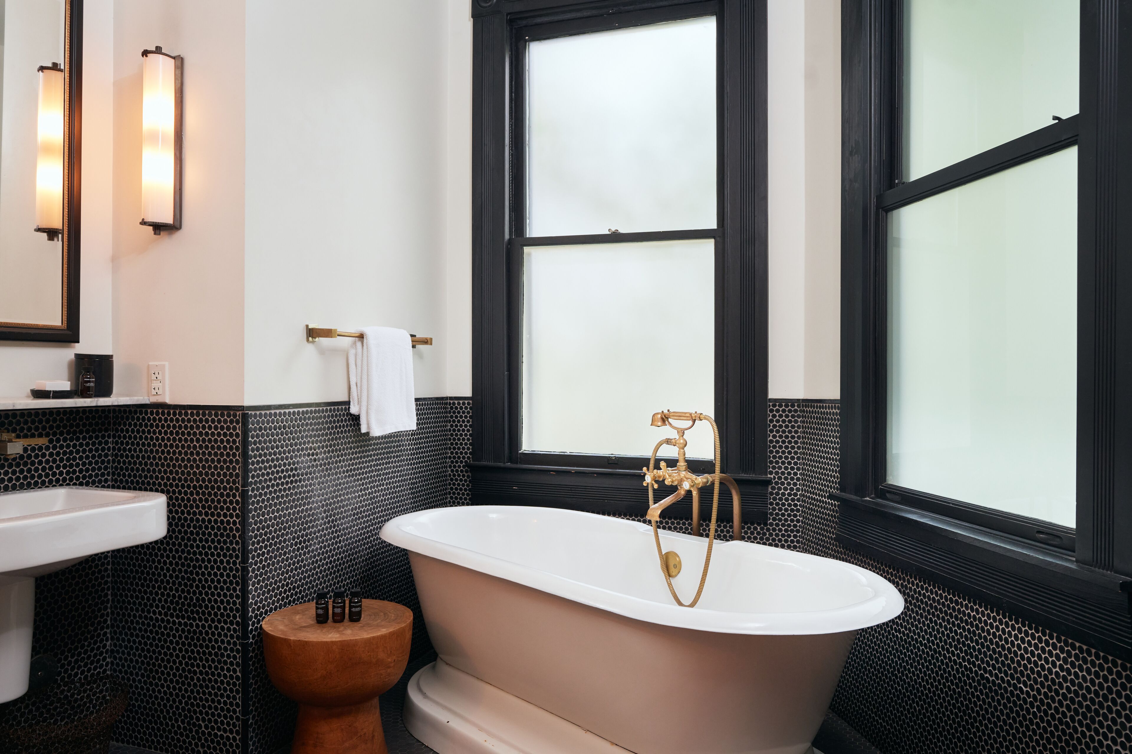 A bathroom with a freestanding bathtub, a sink, and a toilet.