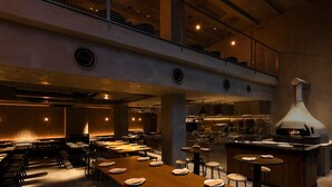 Un restaurant moderne doté de plusieurs espaces de restauration, d’une cuisine centrale et d’une mezzanine.