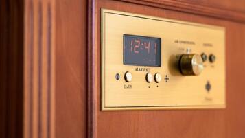 A wooden panel with a digital clock displaying 12:41, an alarm set button, and control knobs.