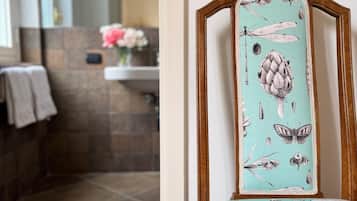A bathroom with a tiled floor, a sink, and a mirror.