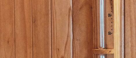 A wooden panel with a vertical scale marked from 0 to 15.