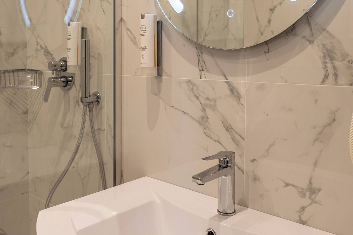 shower, hair dryer, bidet, towels