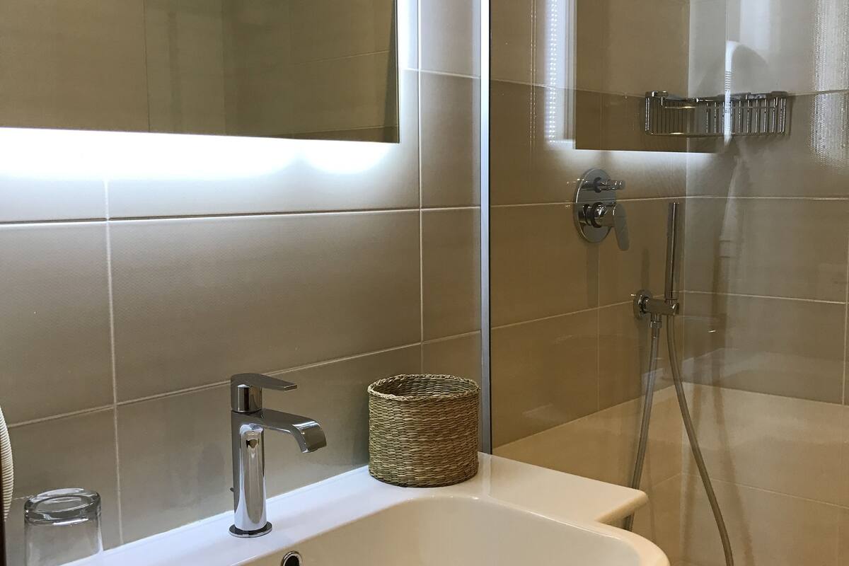 shower, hair dryer, bidet, towels