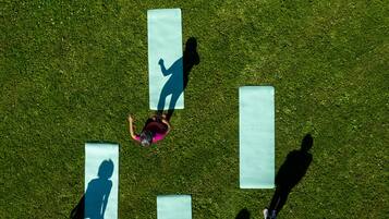 An aerial view of a grassy area with several rectangular objects, possibly mats or boards, arranged in a pattern.