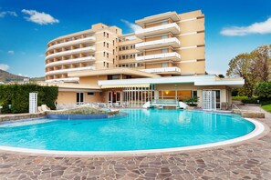 Enjoy a refreshing swim in our pool surrounded by comfortable lounge chairs and a scenic view.