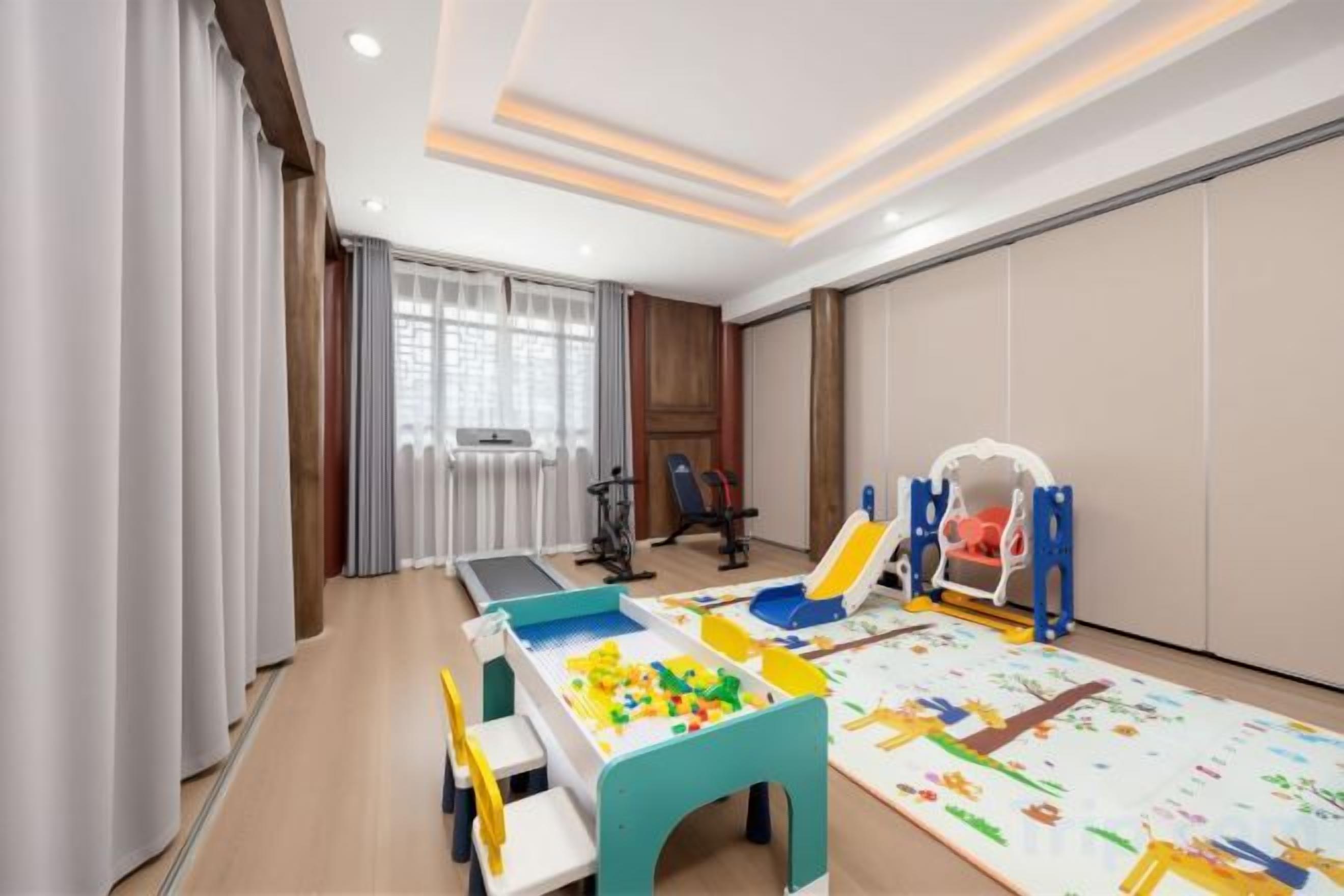 A children's play area with a table, chairs, and toys.