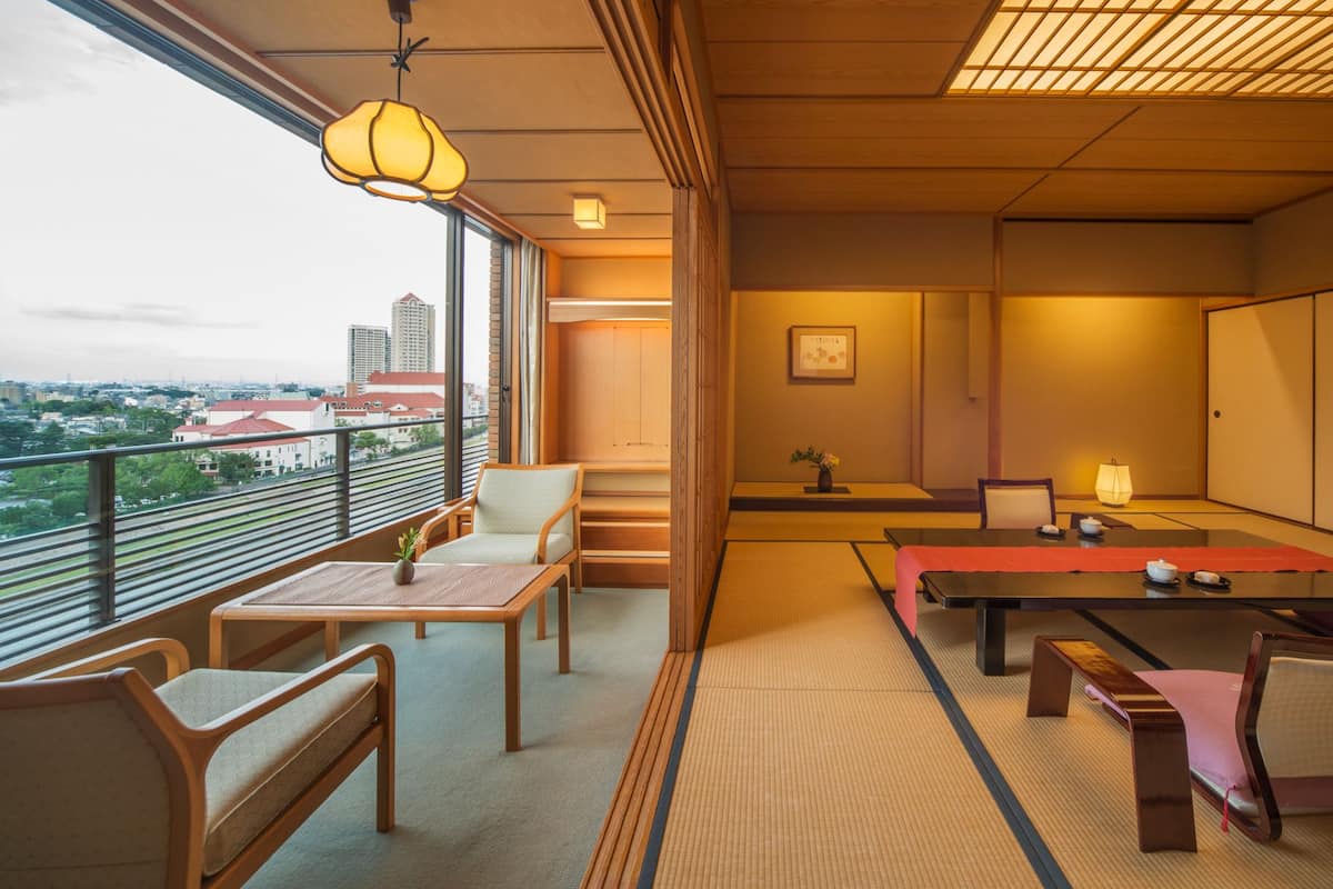 A traditional Japanese-style room with tatami flooring, low tables, and shoji screens.