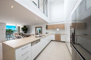 Four Bedroom Two Level Top Floor Luxe Spa Penthouse | Private kitchen | Full-size fridge, microwave, oven, stovetop - at Marina Shores (Cannonvale)
