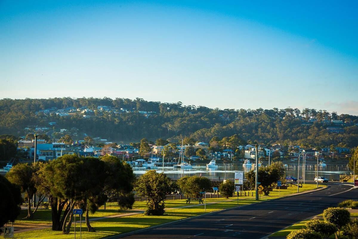 A coastal town with a road leading to a marina.