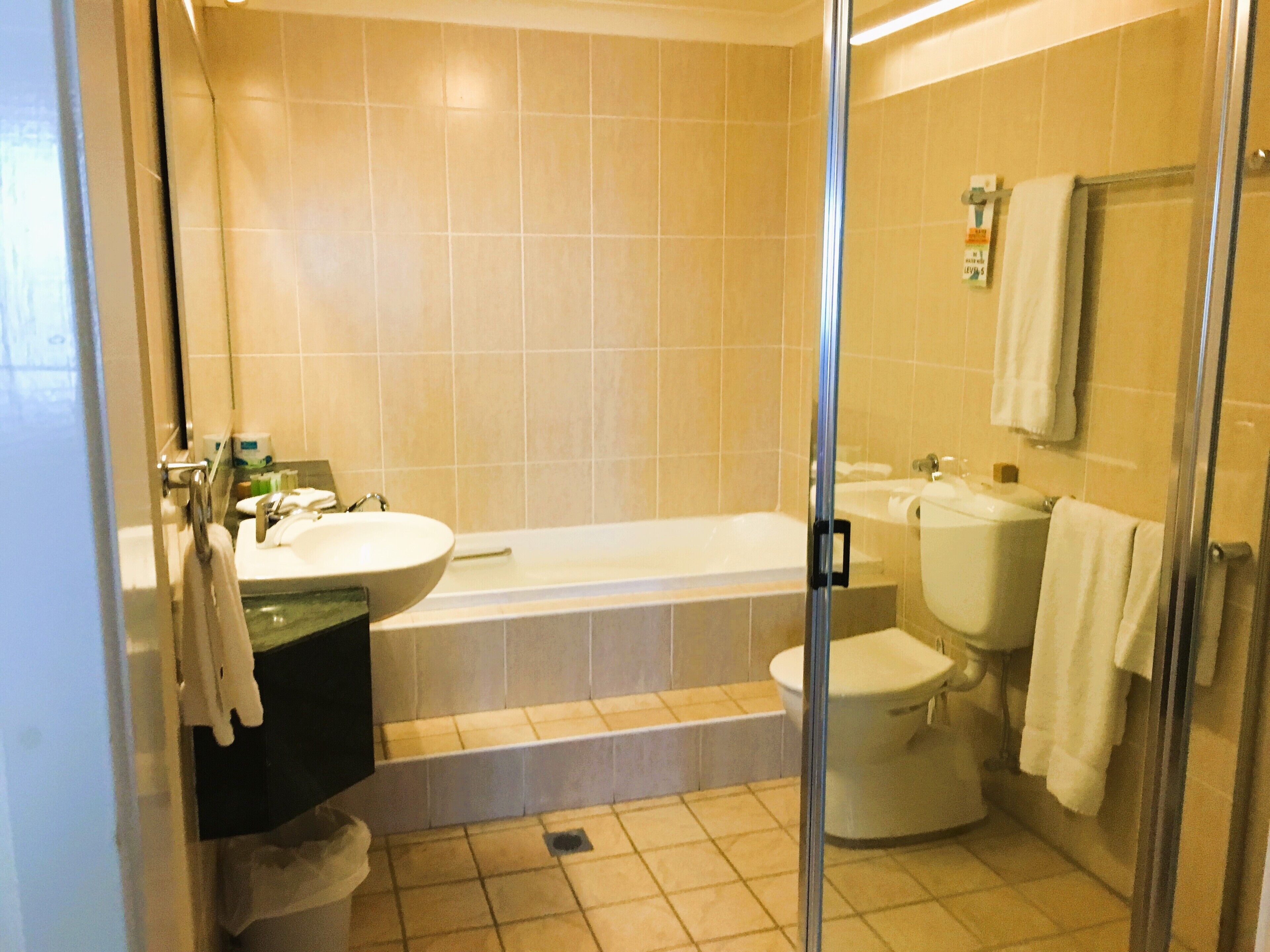 A bathroom with a bathtub, toilet, and sink.