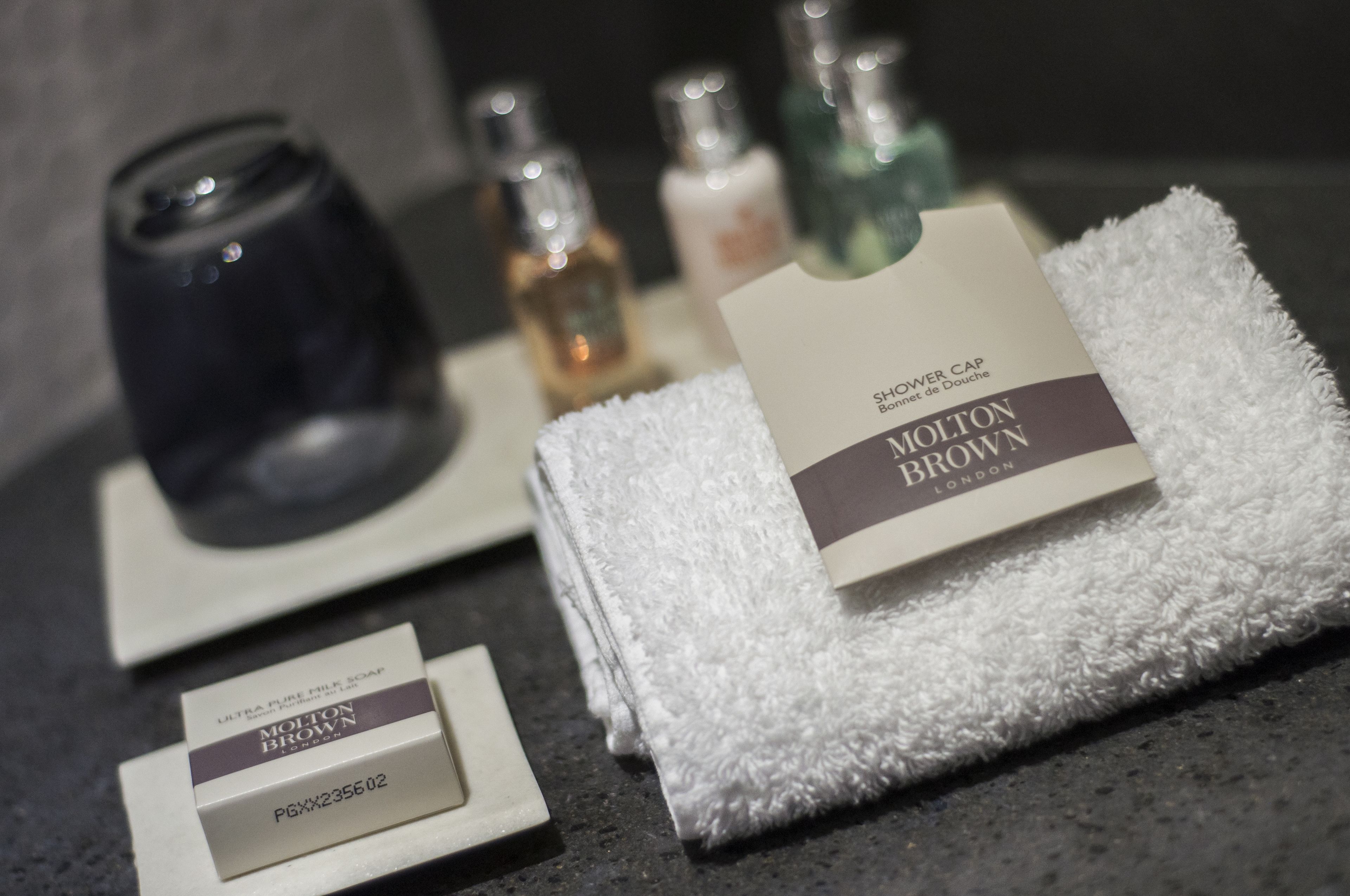 combined shower/bathtub, designer toiletries, hair dryer, towels