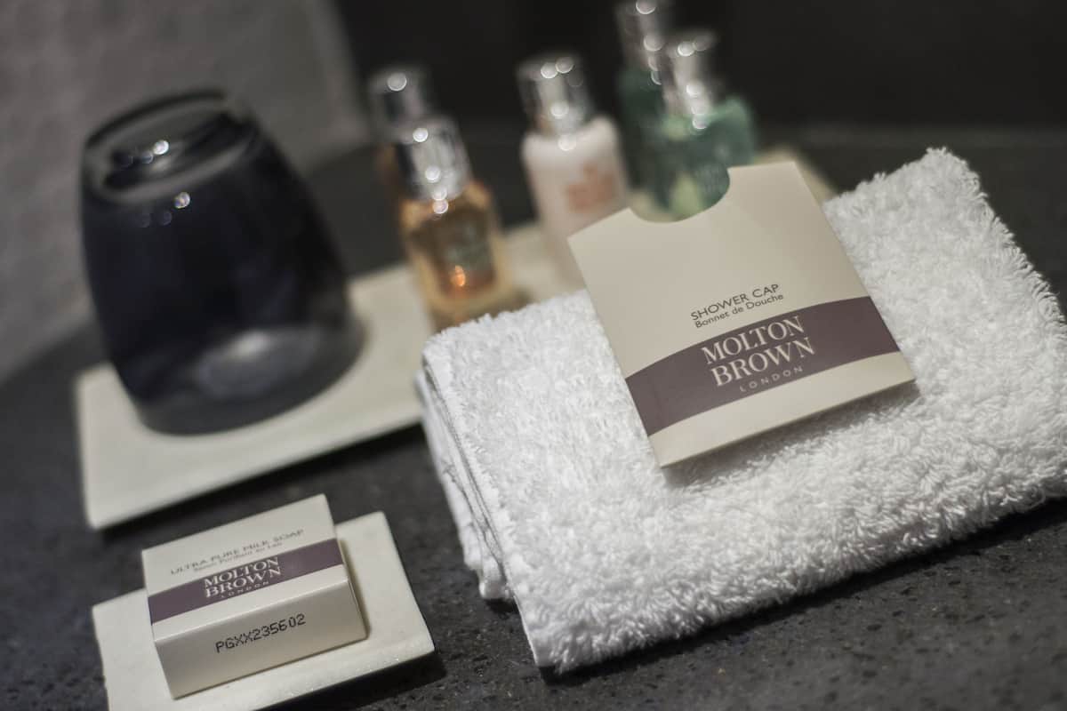 combined shower/bathtub, designer toiletries, hair dryer, towels