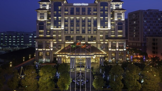 A large, multi-story hotel with a prominent marquee sign at the top. - Marco Polo Jinjiang (Quanzhou)