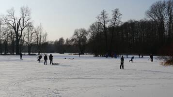 A snowy field with people engaging in winter activities.
