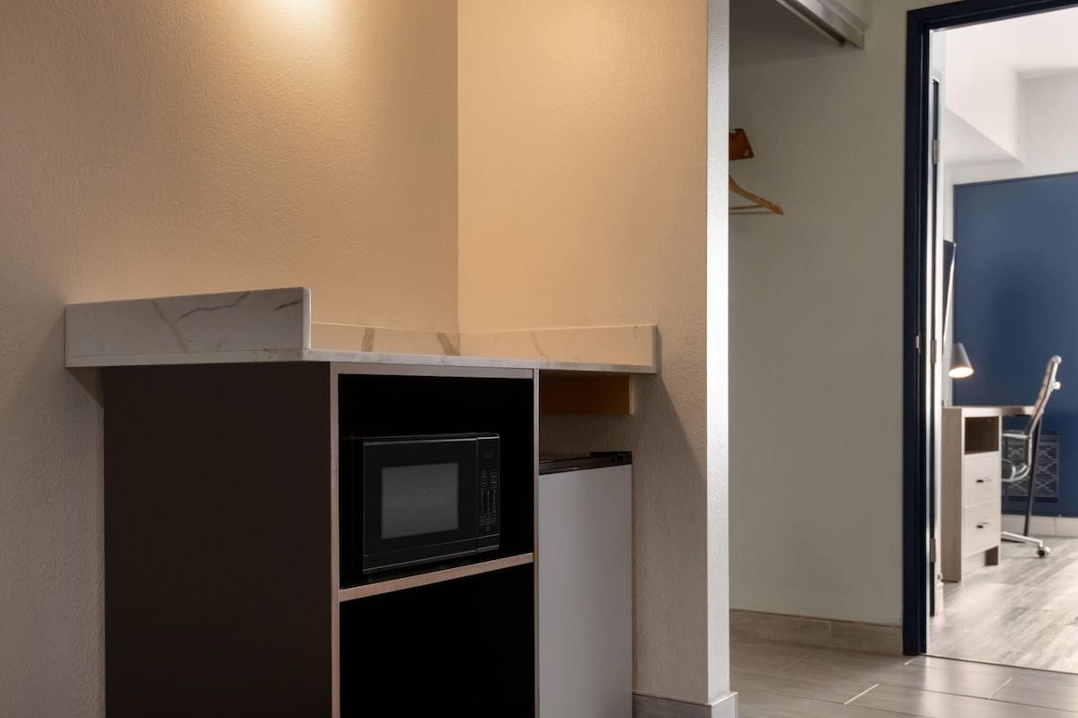 Premium bedding, desk, laptop workspace, blackout drapes