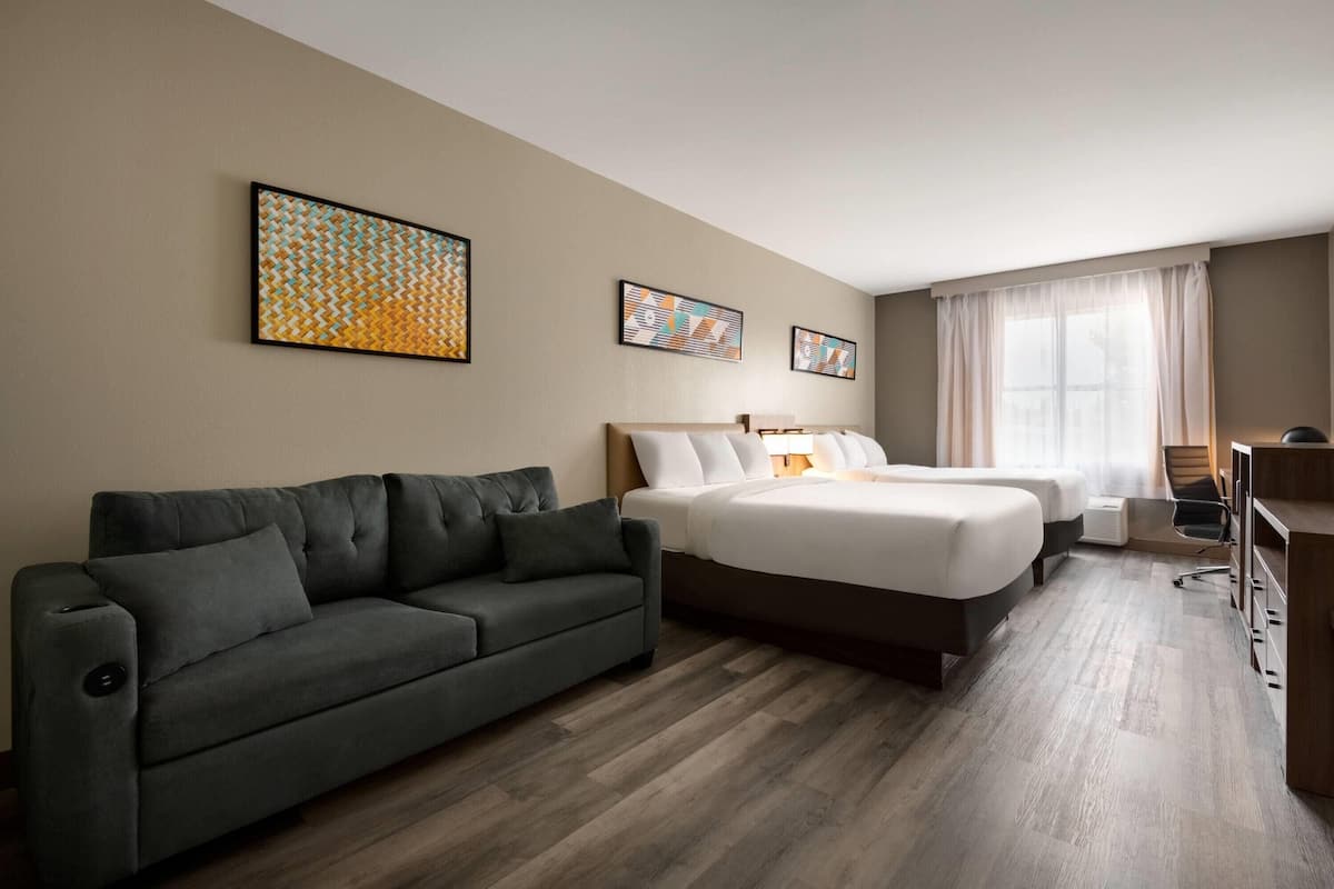 Premium bedding, desk, laptop workspace, blackout drapes