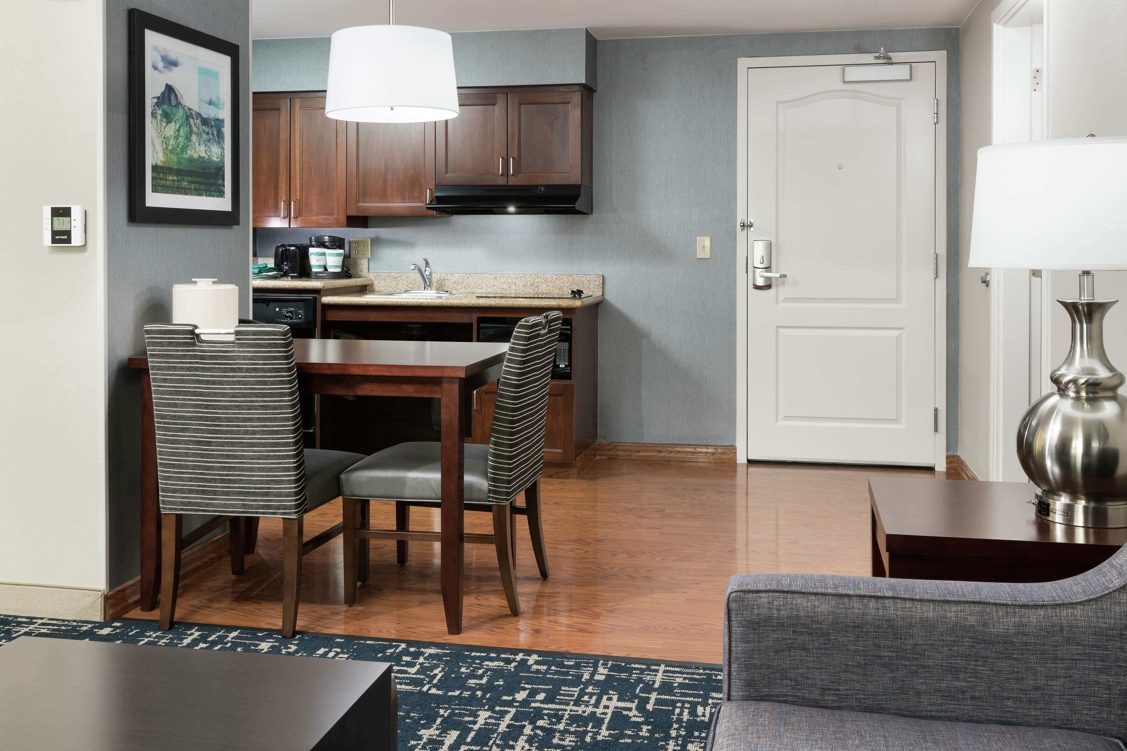 A compact living space with a kitchenette, dining area, and a seating area.