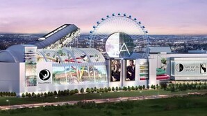 A futuristic building with a large Ferris wheel, a transparent dome structure, and a sign reading "American Dream." - Rodeway Inn Meadowlands (Secaucus)