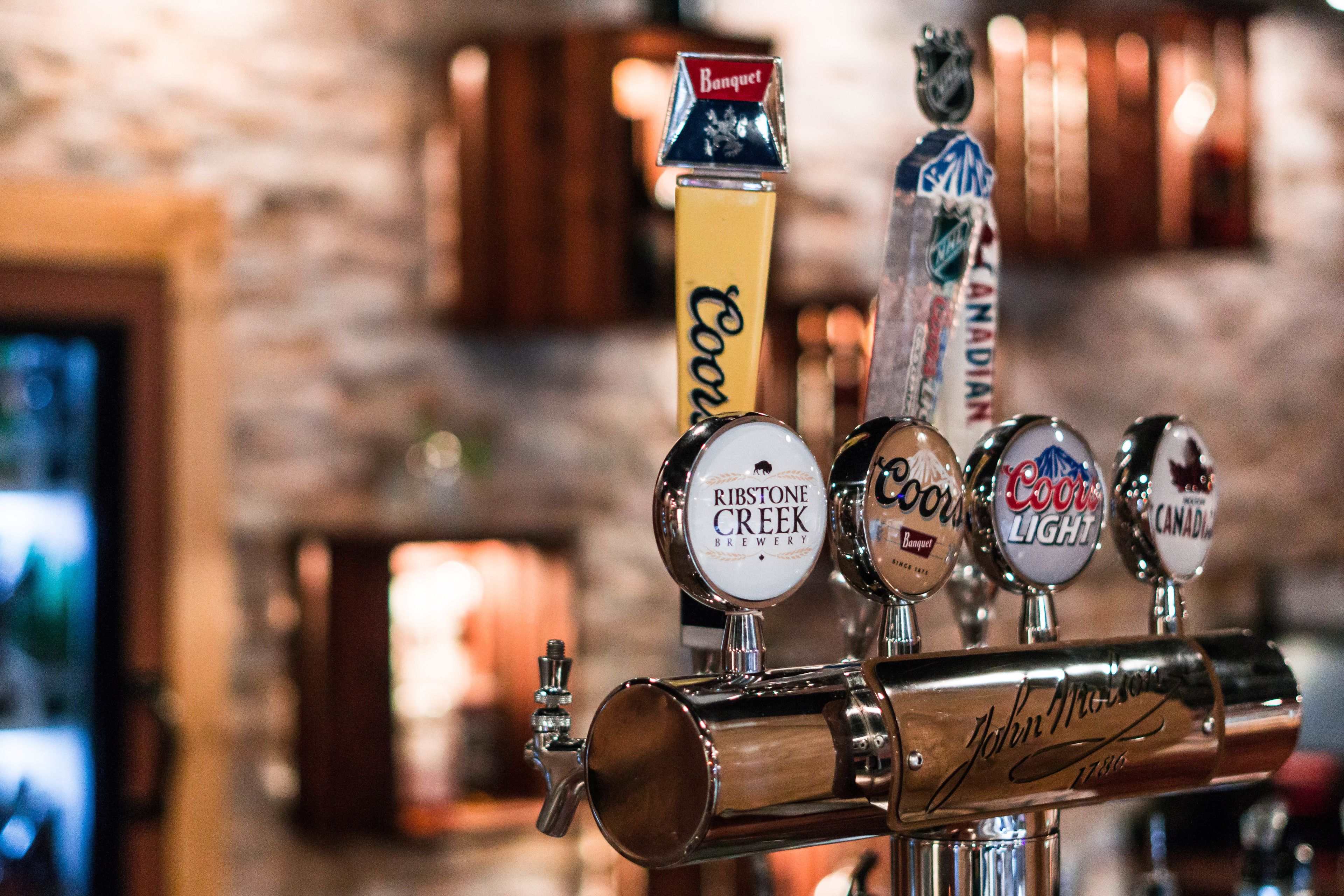 A tap with multiple beer brands including Coors Light and Budweiser.