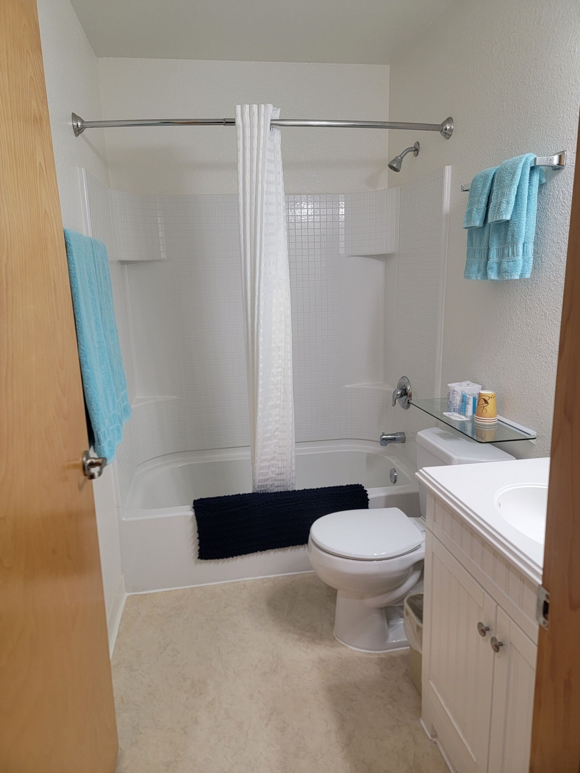 A bathroom with a bathtub, toilet, and sink.