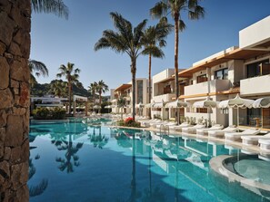 A resort with a swimming pool, palm trees, and modern buildings. - Lesante Classic - Preferred Hotels & Resorts (Zakynthos)