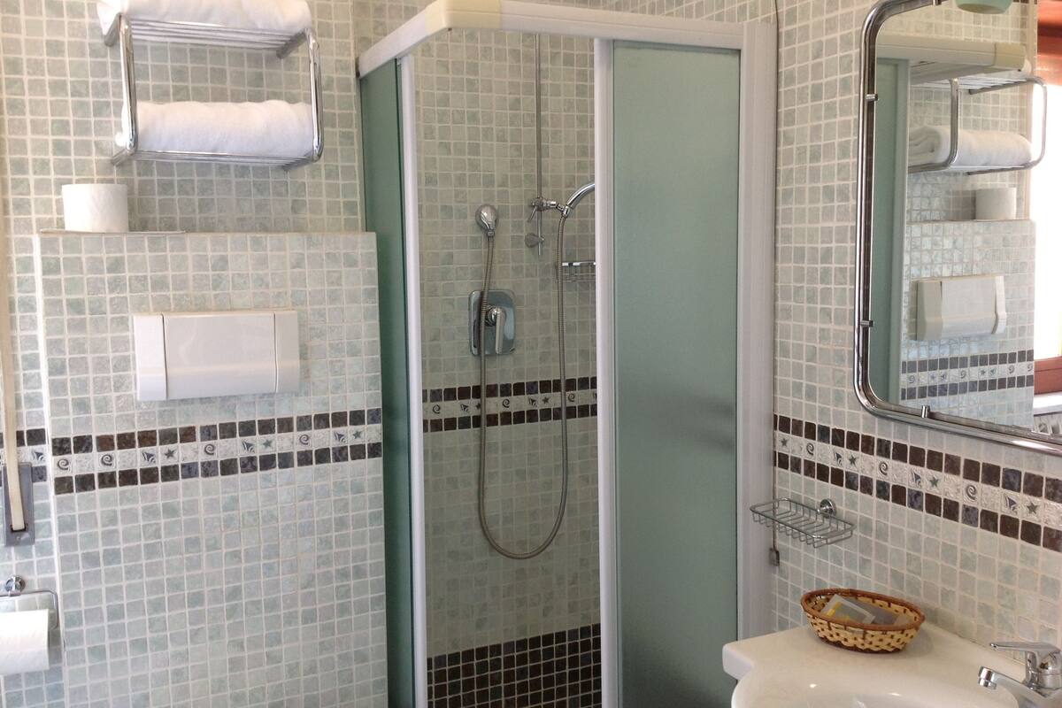 quadruple room | bathroom | rainfall showerhead, free toiletries, hair dryer, slippers
