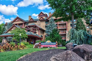 A lodge with a prominent sign, multiple balconies, and a stone facade.