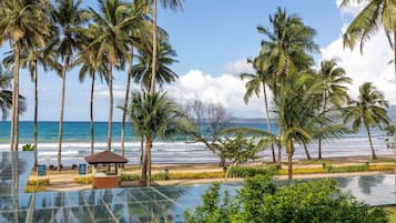 On the beach, white sand, sun-loungers, beach towels