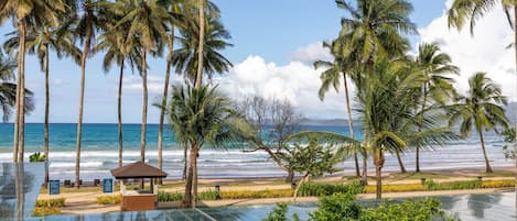 On the beach, white sand, sun loungers, beach towels