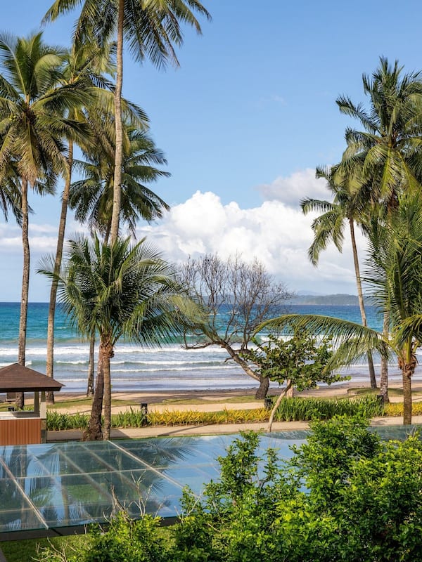 On the beach, white sand, sun loungers, beach towels