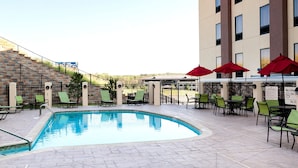 A hotel pool area with two pools, lounge chairs, and umbrellas. - Hampton Inn & Suites Tulsa/Tulsa Hills (Tulsa)