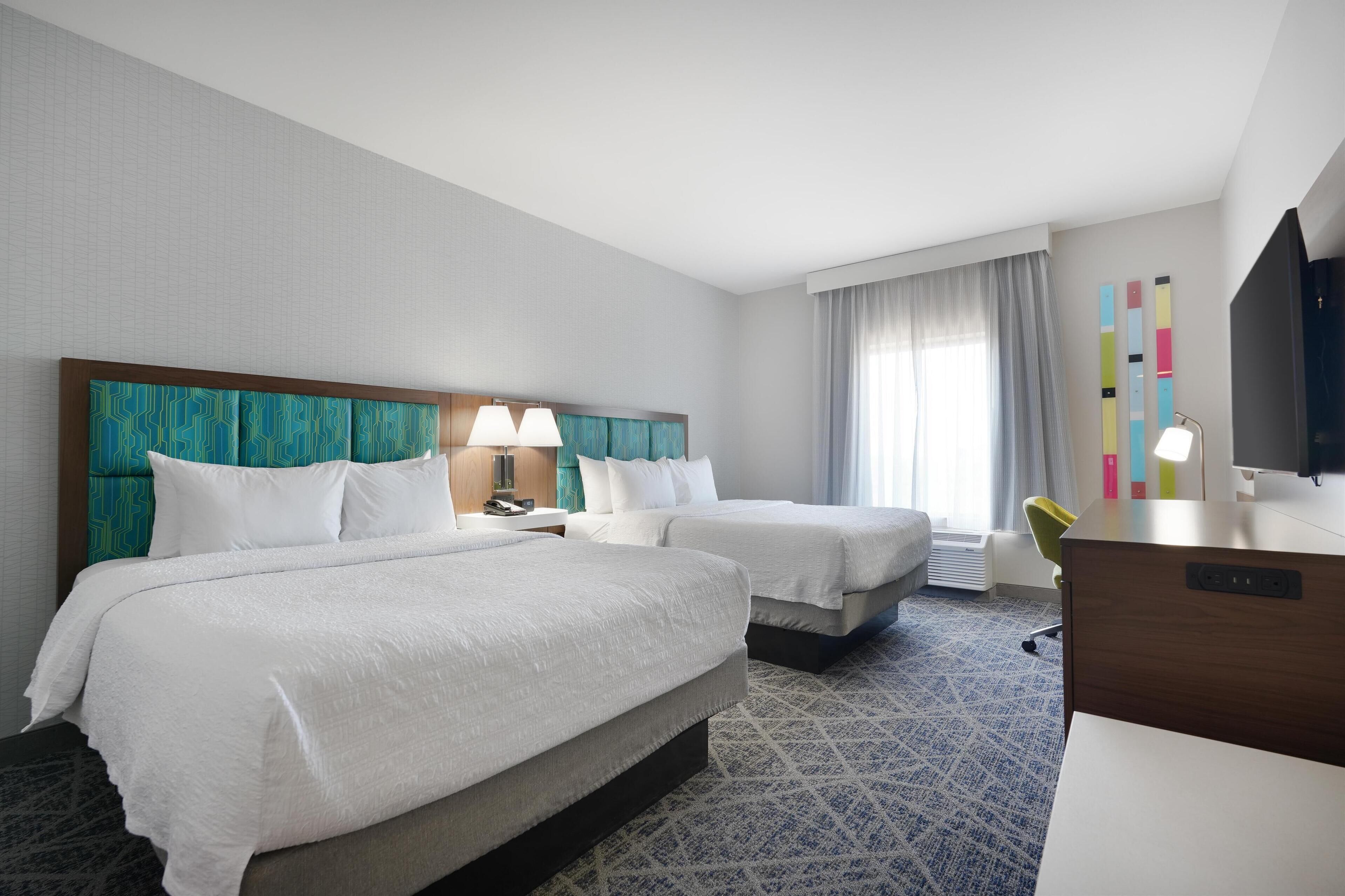 room, 2 queen beds | in-room safe, desk, iron/ironing board, free cots/infant beds