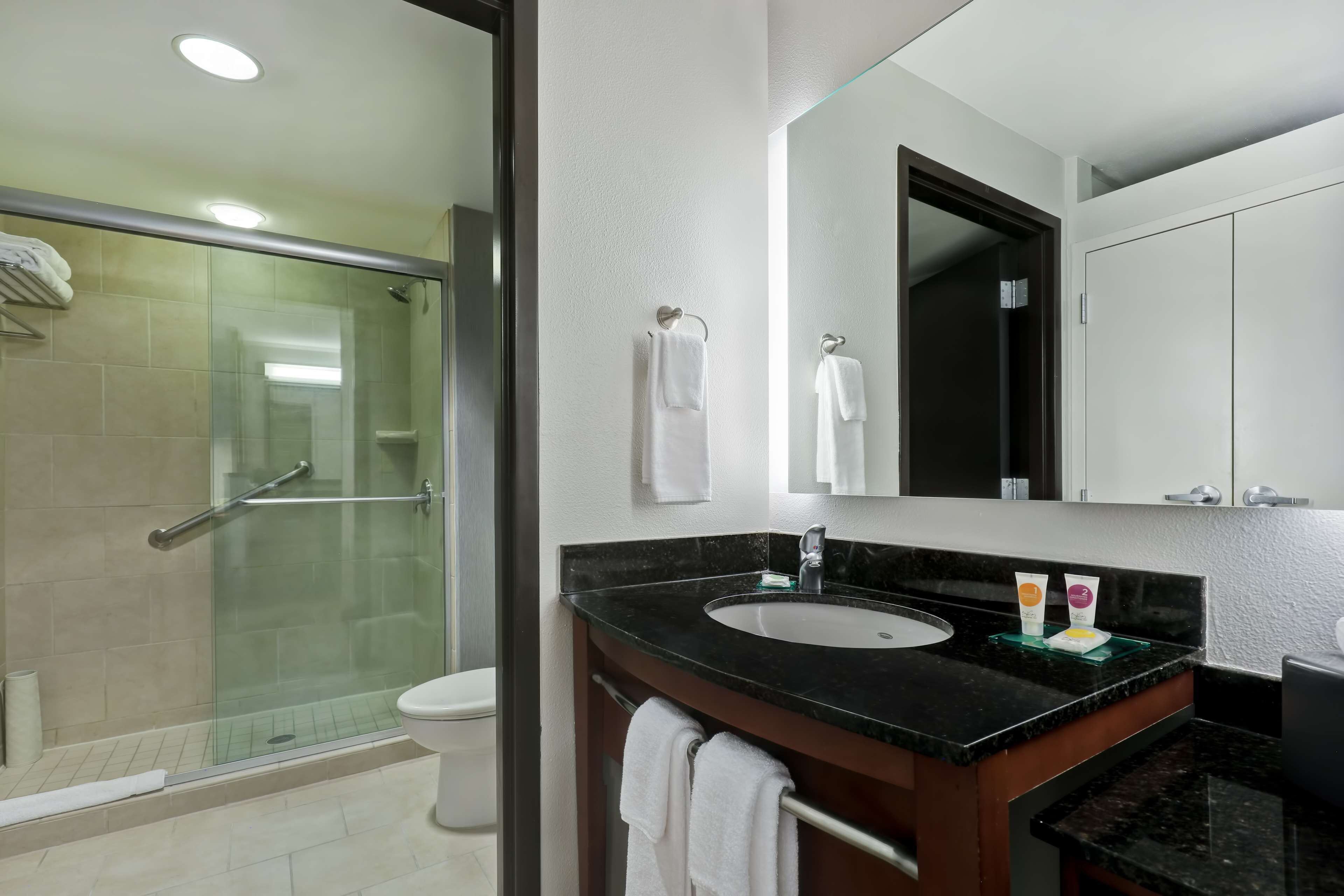 designer toiletries, hair dryer, towels