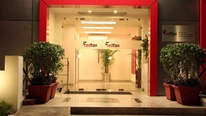 The entrance of Red Fox Hotel with a modern design, featuring a red frame, potted plants, and a signboard. - Red Fox by Lemon Tree Hotels, Jaipur (Jaipur)