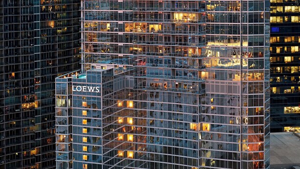 A high-rise building with a glass facade, multiple floors, and a prominent 'LOEWS' sign. - Loews Atlanta Hotel (Atlanta)