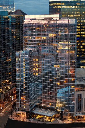 A high-rise building with a glass facade, multiple floors, and a prominent 'LOEWS' sign. - Loews Atlanta Hotel (Atlanta)